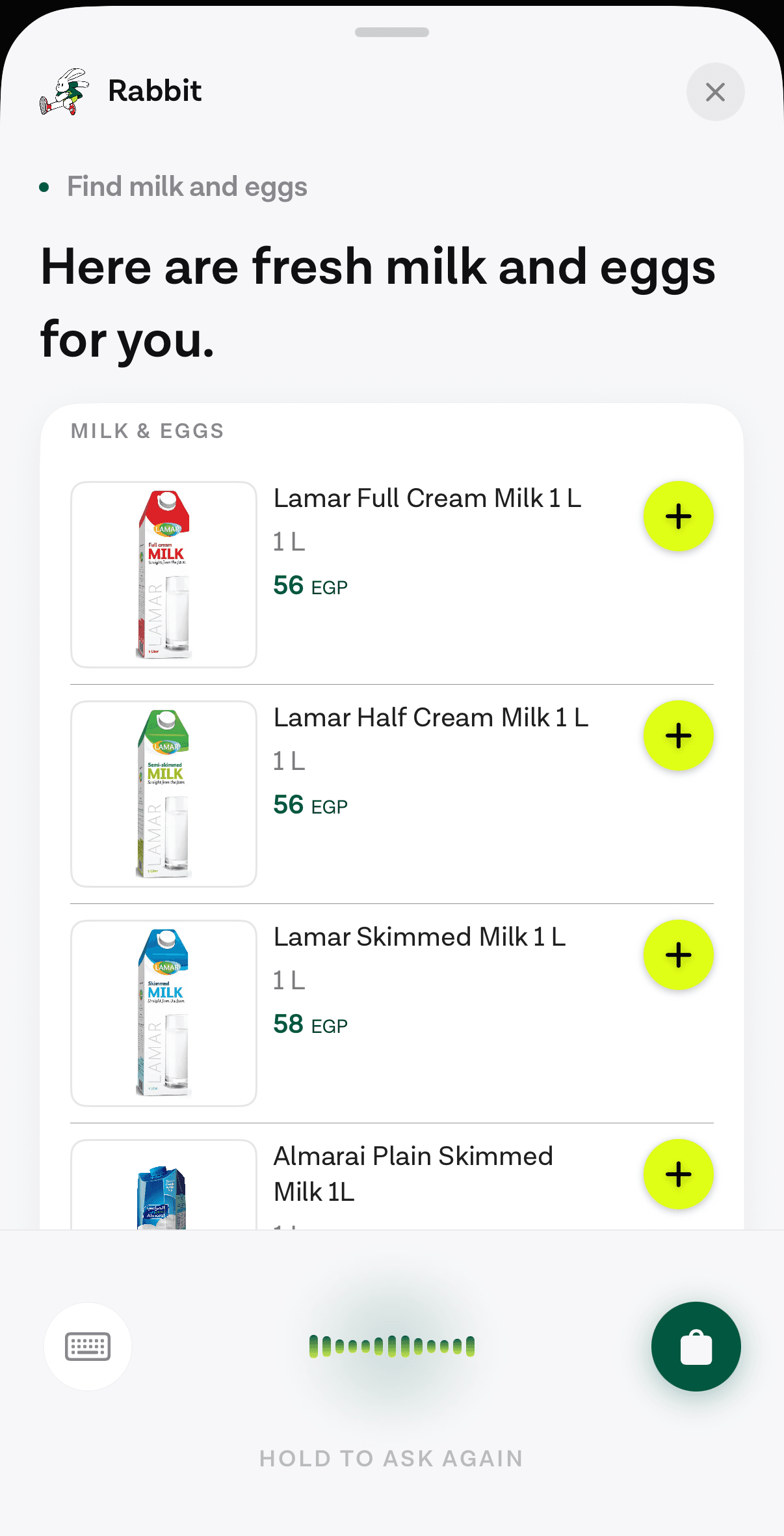 The Voqal assistant sheet inside a grocery app, showing a list of milk products with sizes, prices in Egyptian pounds and an add button on each row.